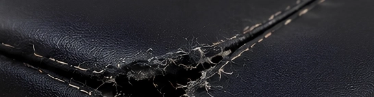 Loose or uneven stitching and weak seams on textile parts